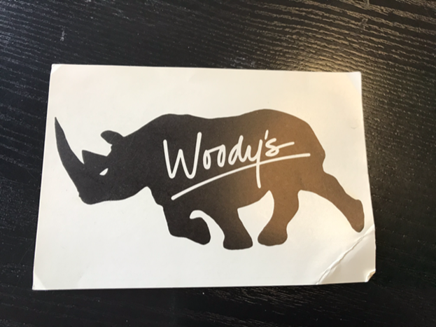 a graphic of a rhinoceros that has the word "Woodys" on the side